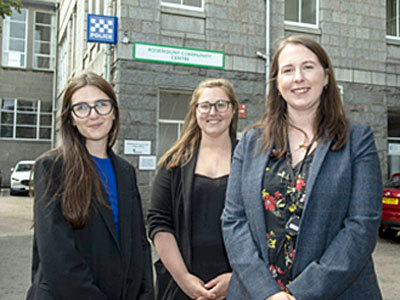 Three woman in front of offices