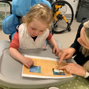 Small child looking at printed sheet