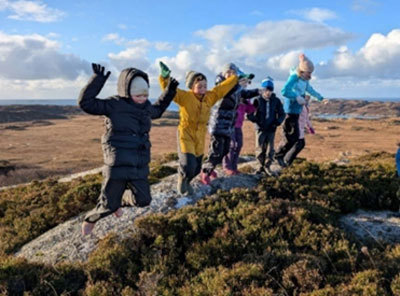 Children jumping off rocks